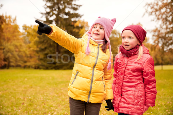 happy little girls pointing finger in autumn park Stock photo © dolgachov