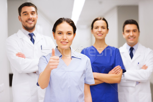 medics or doctors at hospital showing thumbs up Stock photo © dolgachov
