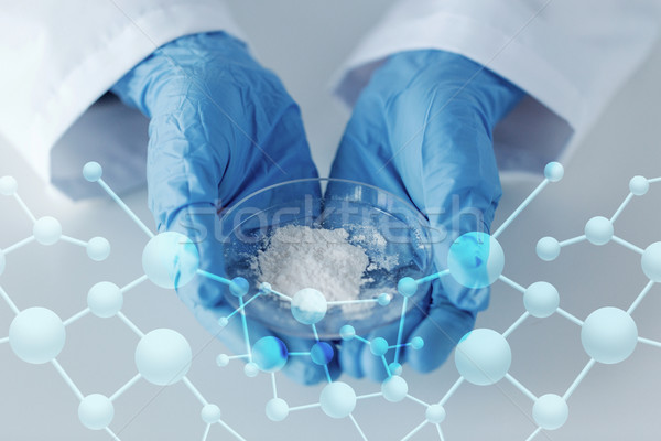 close up of scientist holding petri dish in lab Stock photo © dolgachov