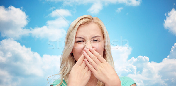 young woman or teenage girl closing her nose Stock photo © dolgachov