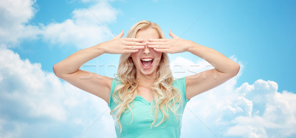 smiling young woman or teen girl covering her eyes Stock photo © dolgachov