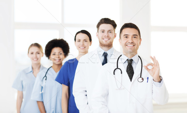 group of happy doctors at hospital Stock photo © dolgachov