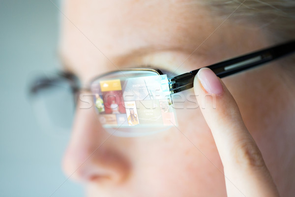 close up of woman in glasses with virtual screen Stock photo © dolgachov