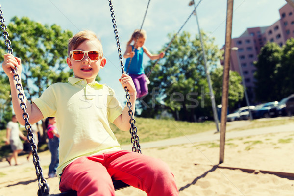 [[stock_photo]]: Deux · heureux · enfants · Swing · aire · de · jeux · été