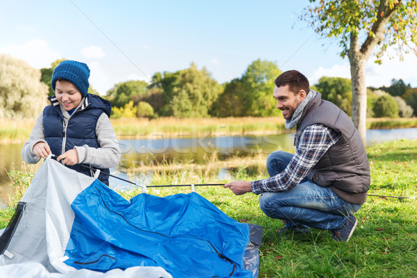 happy father and son setting up tent outdoors Stock photo © dolgachov