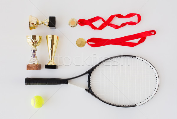 close up of tennis racket, ball, cups and medals Stock photo © dolgachov