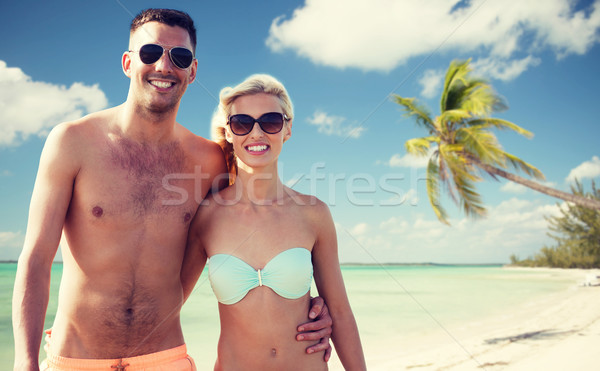 happy couple in swimwear hugging over summer beach Stock photo © dolgachov