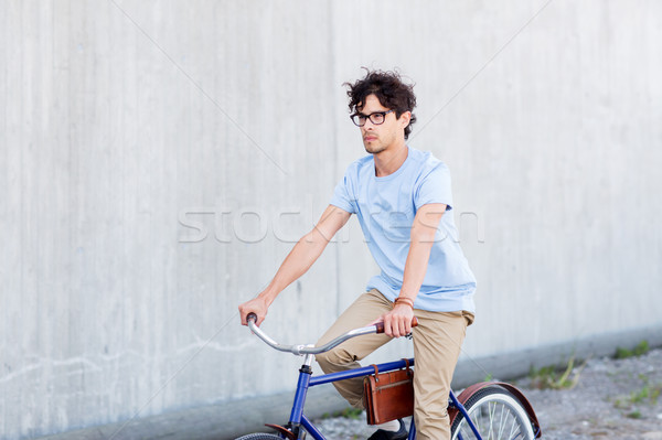 young hipster man riding fixed gear bike Stock photo © dolgachov
