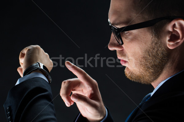 close up of businessman with smart watch Stock photo © dolgachov