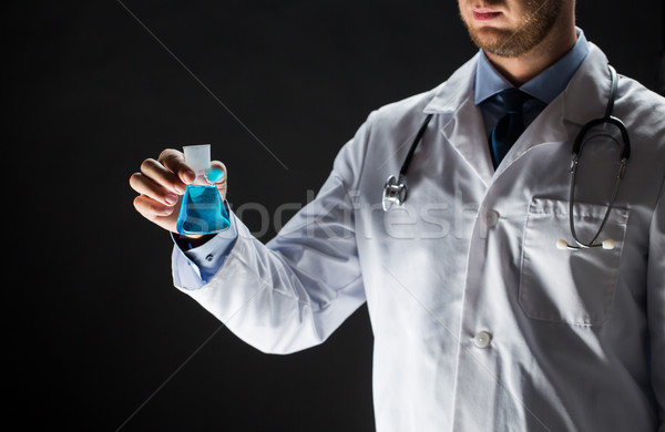 close up of doctor holding flask with cure vaccine Stock photo © dolgachov