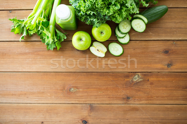 close up of bottle with green juice and vegetables Stock photo © dolgachov
