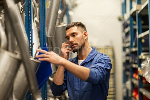 Stock photo: auto mechanic with clipboard at car workshop