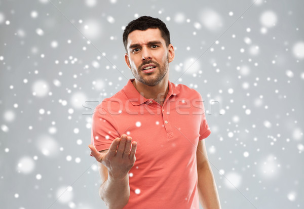 arguing man proving something over snow Stock photo © dolgachov