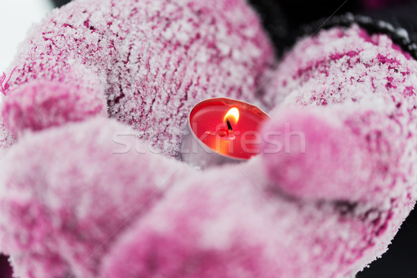 close up of hands in winter mittens holding candle Stock photo © dolgachov