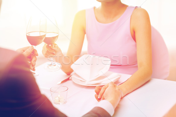 young couple with glasses of wine at restaurant Stock photo © dolgachov