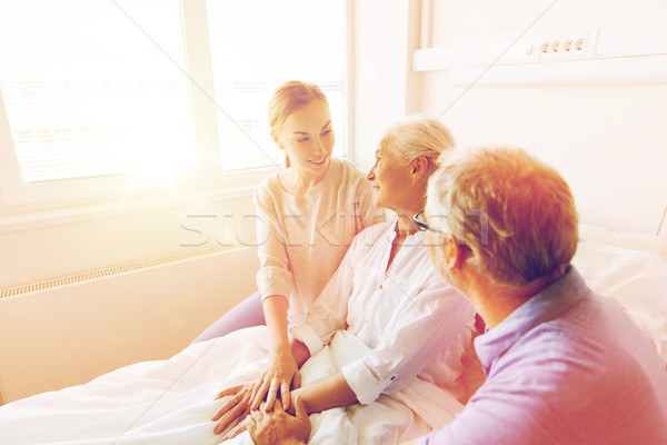happy family visiting senior woman at hospital Stock photo © dolgachov