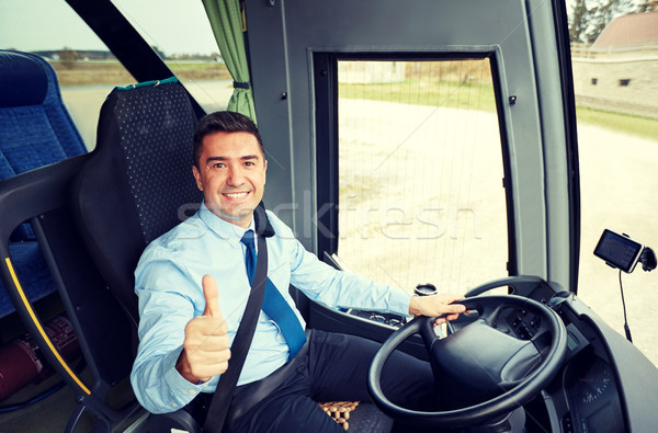 happy driver driving bus and snowing thumbs up Stock photo © dolgachov