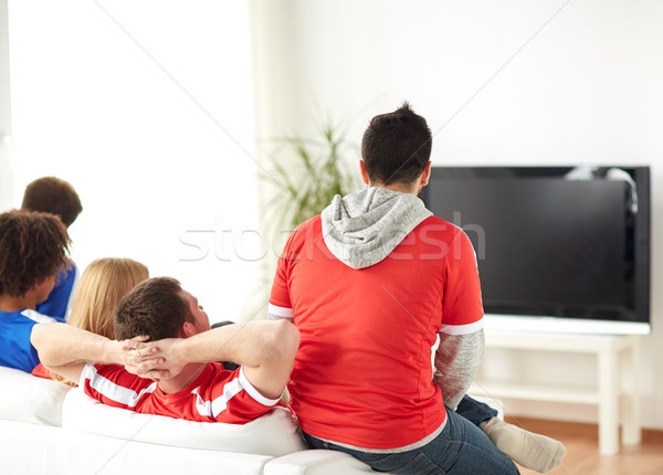 Stock photo: friends or football fans watching tv at home