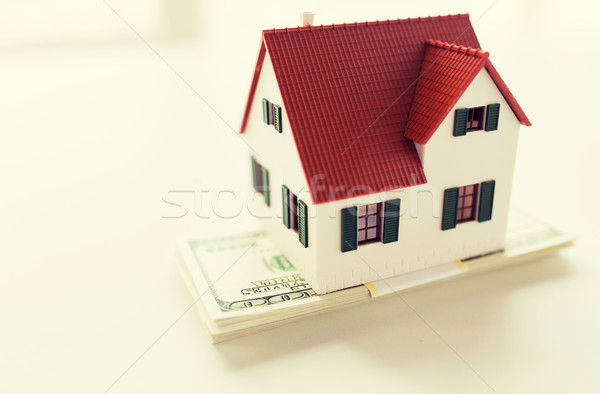 Stock photo: close up of home or house model and money