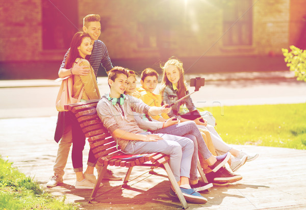 Stock photo: happy teenage students taking selfie by smartphone