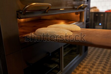 yeast bread dough on oven tray at bakery kitchen Stock photo © dolgachov