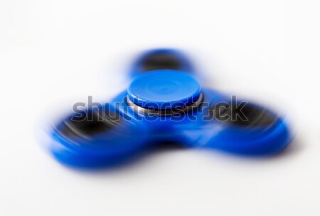 close up of blue spinning fidget spinner Stock photo © dolgachov