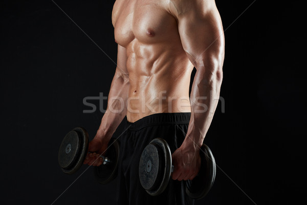 close up of man with dumbbells exercising Stock photo © dolgachov