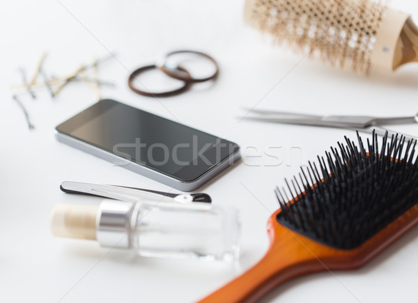 smartphone, scissors, brushes and other hair tools Stock photo © dolgachov