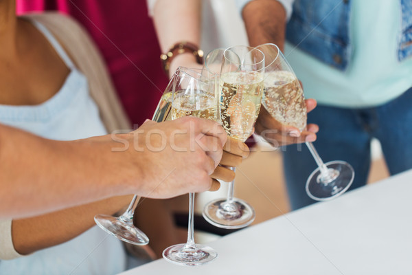 friends clinking glasses of champagne at party Stock photo © dolgachov