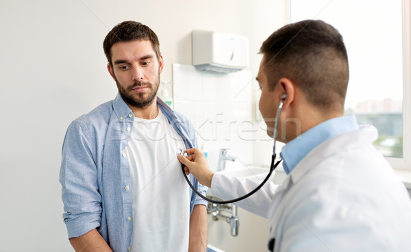 doctor with stethoscope and patient at hospital Stock photo © dolgachov