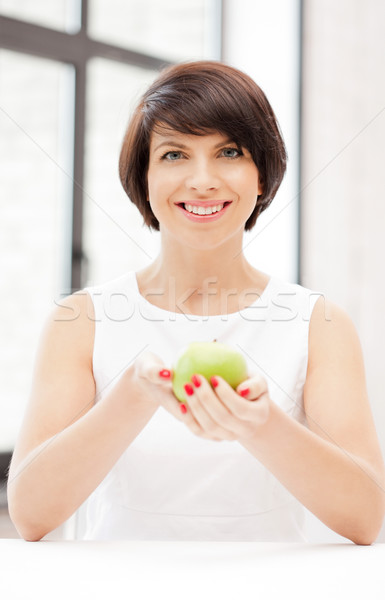 lovely housewife with green apple Stock photo © dolgachov