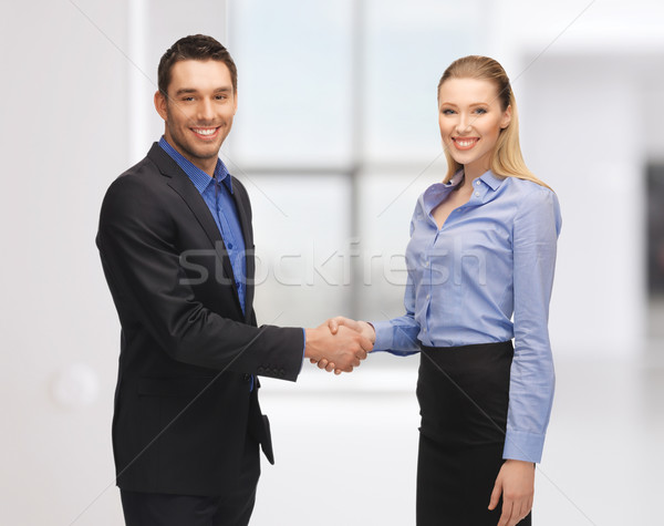 man and woman shaking their hands Stock photo © dolgachov