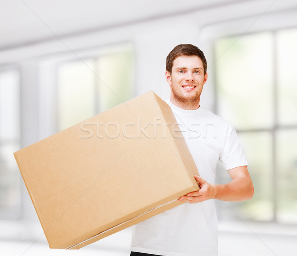 smiling man carrying carton box Stock photo © dolgachov