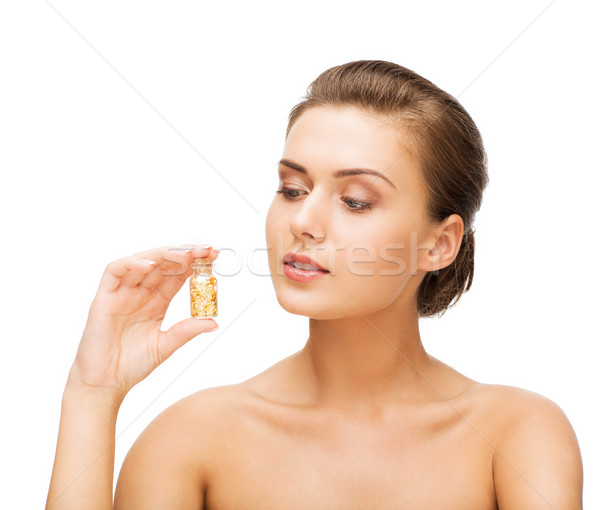 Belle femme bouteille or poussière beauté Photo stock © dolgachov