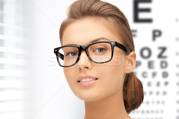 Stock photo: woman in eyeglasses with eye chart