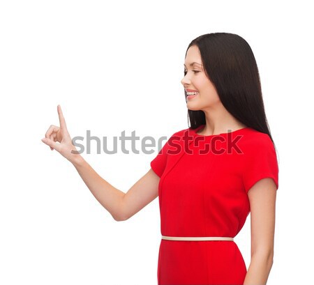 Vestido rojo senalando dedo anuncio atractivo Foto stock © dolgachov