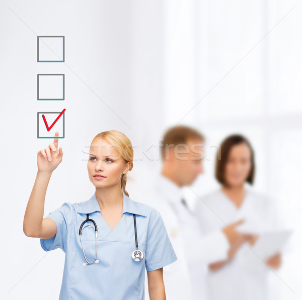 Gülen doktor hemşire işaret sağlık tıp Stok fotoğraf © dolgachov