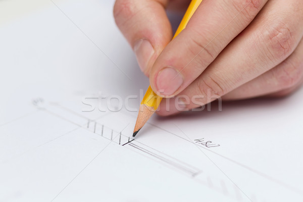 male contractor making changes to blueprint Stock photo © dolgachov