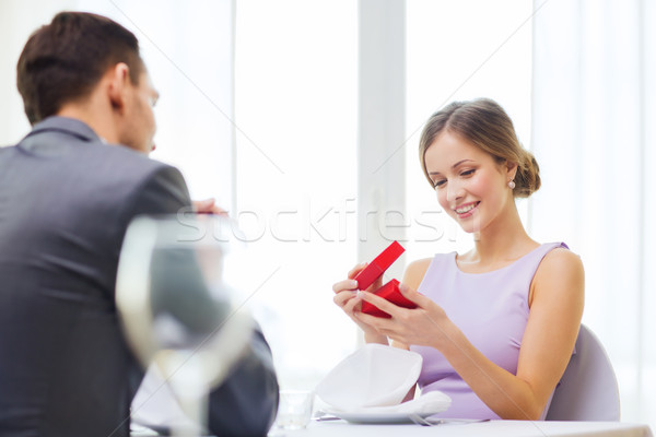 Excité jeune femme regarder copain boîte restaurant [[stock_photo]] © dolgachov