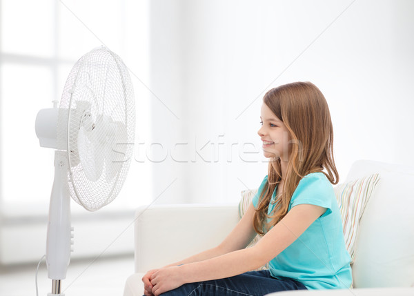 smiling little girl with big fan at home Stock photo © dolgachov