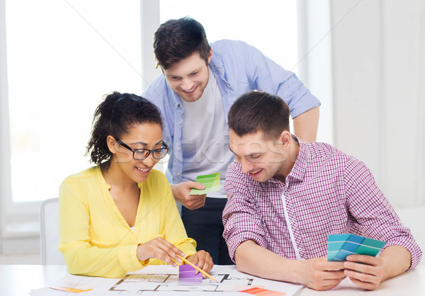Stock photo: smiling interior designers working in office