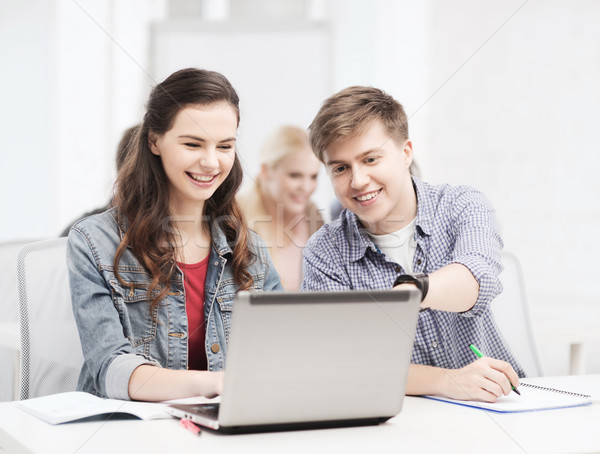 students with laptop and notebooks at school Stock photo © dolgachov