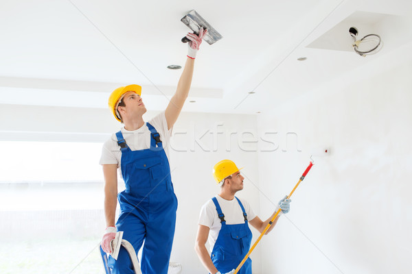 group of builders with tools indoors Stock photo © dolgachov