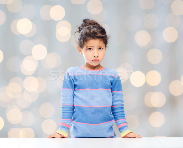 sad little girl over city background Stock photo © dolgachov