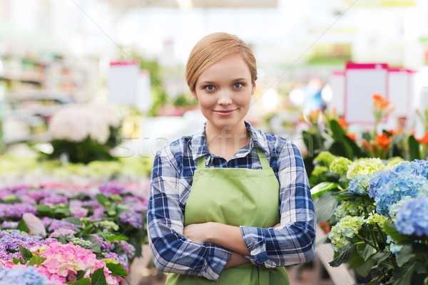 happy woman with flowers in greenhouse Stock photo © dolgachov