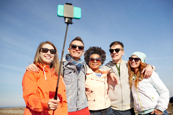 smiling friends taking selfie with smartphone Stock photo © dolgachov