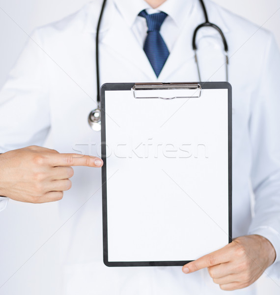 doctor pointing at blank white paper Stock photo © dolgachov