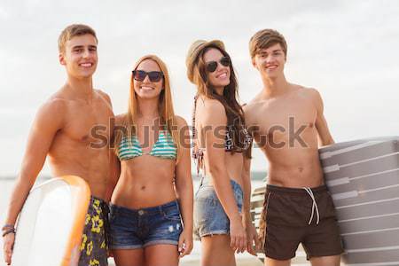 happy couple sunbathing in chairs on summer beach Stock photo © dolgachov