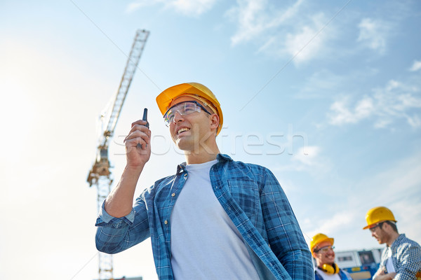 Stock photo: builder in hardhat with walkie talkie