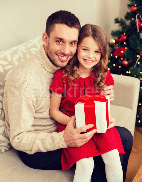 smiling father and daughter holding gift box Stock photo © dolgachov